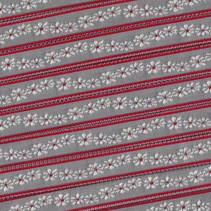 May include: Red and gray striped fabric with a white floral pattern. The fabric has a subtle sheen and a textured surface.