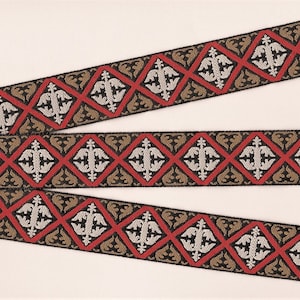 May include: Three pieces of black, red, gold, and silver patterned trim with a repeating diamond design.