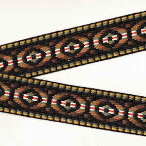 May include: Black and brown woven ribbon with a geometric pattern featuring circles, ovals, and stripes in red, white, and green.