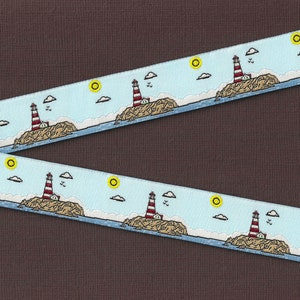 May include: A blue and white ribbon with a repeating pattern of red and white lighthouses on islands with yellow suns and white clouds.