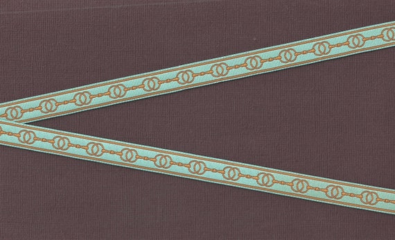 B-DP-05e GEOMETRIC Jacquard Ribbon Poly Trim, 1/2" Wide (13mm) Horse Snaffle Bit Design in Mustard Gold on Aqua Background, Per Yard