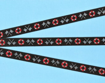 May include: Three black ribbons with a repeating pattern of red and white life preservers, crossed flags, and a black background.