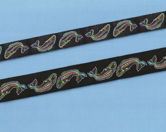 May include: Black ribbon with a repeating pattern of colorful fish. The fish are outlined in black and have a variety of colors, including red, green, blue, and yellow.