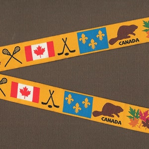 Nastro Jacquard RDS 30-A in poliestere, larghezza 7/8" (22 mm), giallo dorato caldo con simboli canadesi, emblemi, bandiera, hockey e lacrosse