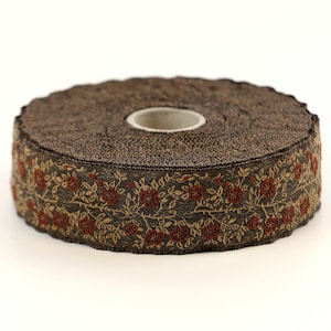 May include: A roll of brown trim with a gold and red floral pattern. The trim has a scalloped edge.