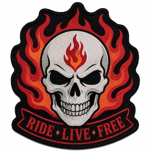 May include: An embroidered patch featuring a central white skull with a red and orange flame on its forehead, surrounded by larger red and orange flames on a black background. A red banner at the bottom displays the text RIDE LIVE FREE.