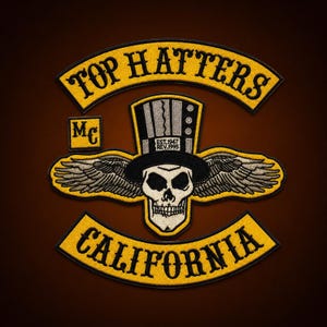 May include: An embroidered patch featuring a skull wearing a top hat with wings, the text TOP HATTERS in a yellow arch, CALIFORNIA in a yellow bottom arch, and a small square MC patch. The top hat includes the text EST.1947 REV.1995 in black.
