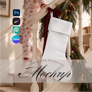 May include: A plain white Christmas stocking with a folded cuff, hanging from a white wooden staircase banister adorned with a dark red velvet bow and evergreen garland. The text CHRISTMAS STOCKING Mockup is overlaid in black script and sans-serif font.