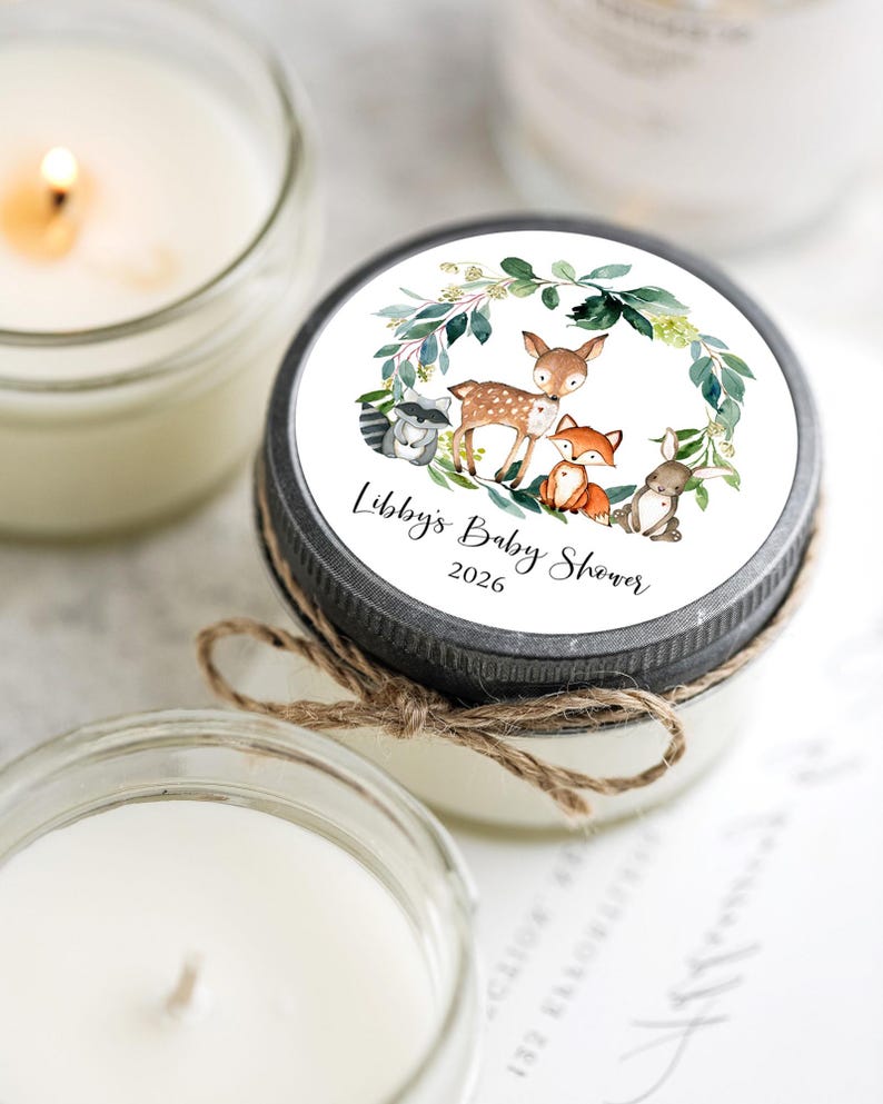 Close-up of personalized woodland candle label with fox, deer, rabbit and raccoon design for baby shower favor