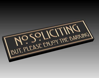 May include: A rectangular black sign with gold lettering that reads "NO SOLICITING BUT, PLEASE ENJOY THE BARKING." The sign has a gold border and is likely made of metal or a similar material.