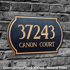 May include: A dark walnut wood house number sign with gold trim. The sign reads "37243 CANON COURT".