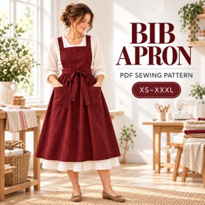 Op de afbeelding: Een donkerrood schort met een strikceintuur en twee grote voorzakken, gedragen over een witte jurk met lange mouwen. De tekst op de afbeelding luidt BIB APRON PDF SEWING PATTERN XS-XXXL. Het schort heeft brede schouderbanden en een wijde rok.