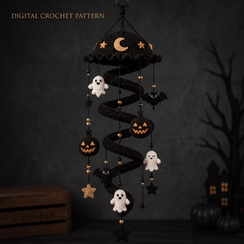May include: A hanging spiral crochet mobile featuring black yarn with dangling white ghosts, orange jack-o'-lanterns, black bats, and gold stars. The top canopy is decorated with a yellow crescent moon and stars. Text reads DIGITAL CROCHET PATTERN.