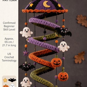 May include: A spiral Halloween-themed crochet mobile featuring a purple top with a yellow crescent moon and stars. The structure hangs with dangling crocheted figures including white ghosts, orange jack-o'-lanterns, black bats, and purple stars, measuring 55 cm long.