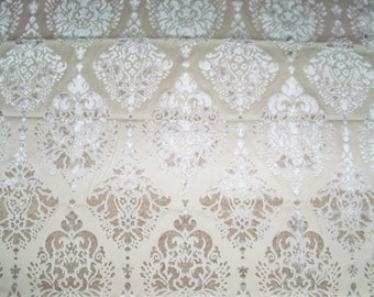 May include: White fabric with a silver damask pattern. The fabric has a subtle sheen and a soft texture.