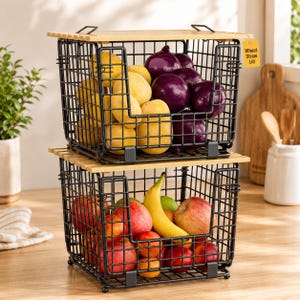 May include: Two stackable black wire storage baskets with light-colored wooden lids. The top basket contains yellow potatoes and purple onions. The bottom basket holds red apples, a yellow banana, and small oranges. A tag reads Wheat Straw Lid.