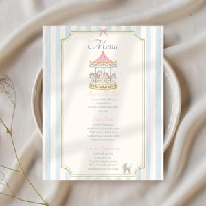 May include: A rectangular menu card featuring a light blue and white vertical striped border. The center displays a pink carousel illustration at the top, the word Menu, and a list of food items, finished with a small baby carriage icon at the bottom.