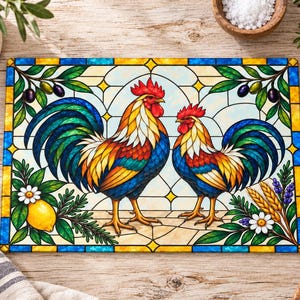 May include: A rectangular glass cutting board featuring a stained glass style illustration of two roosters. The design includes vibrant red, blue, and yellow feathers, surrounded by green olive branches, yellow lemons, and wheat stalks.