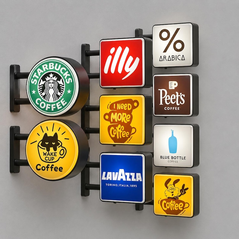 May include: A wall-mounted display featuring multiple illuminated signs with various coffee brand logos and graphics, including Starbucks, illy, Arabica, Peet's, Blue Bottle, Lavazza, and custom designs with text like I Need More Coffee and Wake Cup.
