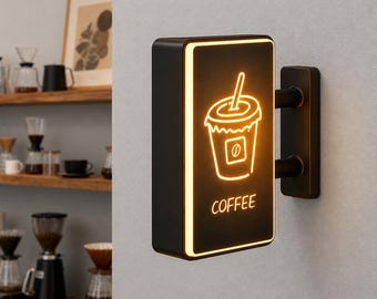 Könnte beinhalten: Ein rechteckiges, schwarzes Wand-Schild mit einer leuchtend orangefarbenen Neon-Kontur eines Kaffeebechers mit Strohhalm und dem Wort COFFEE in orange unter der Grafik. Das Schild hat einen schmalen beleuchteten Rand und eine schwarze Halterung.