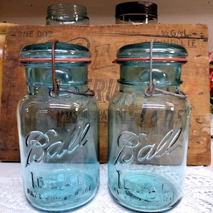Two IMPERFECT Antique Aqua Blue Ball Ideal Quart Sized Jars with Wire Bails and Nice Aqua Colored Glass Lids Some HAZE to One Jar Lips ROUGH