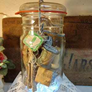 One vintage IMPERFECT quart sized Ball Eclipse WIDE MOUTH jar wire bail glass lid filled wooden thread spools, small blocks, clothespins