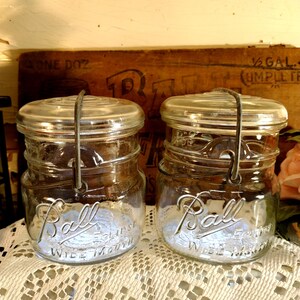 Two Vintage IMPERFECT Clear PINT Sized Ball Eclipse WIDE Mouth jars with wire bails and imperfect wide mouth glass lids Rust to bails