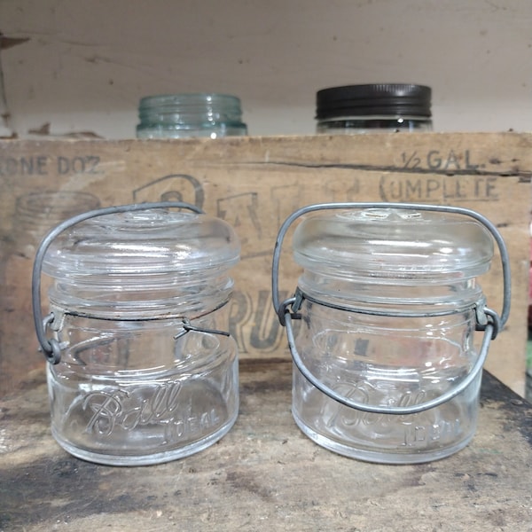 Two Vintage 1/2 or 1/3 Pint Clear Ball Ideal Jars with Wire Bails and Glass Lids Standard Mouth SMALL CHIP to One Please Read Description