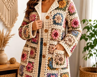 May include: A long-sleeved cardigan made of cream-colored yarn featuring a multi-colored granny square pattern in shades of pink, blue, yellow, and brown. The garment has a notched collar, four brown buttons down the front, and two front pockets.