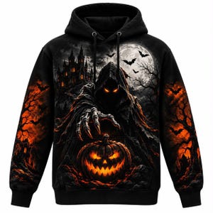 May include: A black hooded sweatshirt featuring a graphic print of a hooded figure with glowing orange eyes reaching toward a glowing jack-o'-lantern. The background displays a dark castle, a full moon, flying bats, and orange-lit trees.