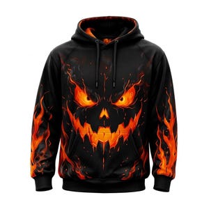 May include: A black long-sleeve hooded sweatshirt featuring a graphic print of a glowing orange and yellow fire-themed jack-o'-lantern face on the front. The sleeves and torso are decorated with orange flame patterns, and the hood has drawstrings.