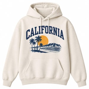 May include: A cream-colored hooded sweatshirt featuring a graphic print on the chest. The design includes the word CALIFORNIA in dark blue arched text above a coastal scene with palm trees, a large orange sun, and a mountain silhouette.