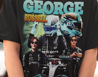 May include: A black short-sleeve t-shirt featuring a graphic print of Formula 1 driver George Russell. The design includes the text GEORGE RUSSELL, images of the driver in racing gear, a racing helmet, and a Mercedes-AMG Petronas race car.