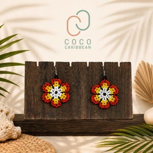 May include: A pair of flower-shaped earrings crafted from small beads in a vibrant color palette of red, yellow, and white. The earrings feature a central white cluster surrounded by yellow and red petals, suspended from silver-toned metal hooks.