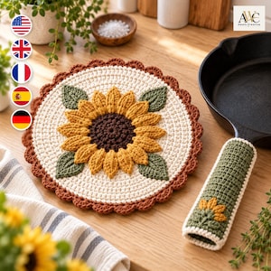 Könnte beinhalten: Ein runder, cremefarbener Häkel-Topflappen mit einem zentralen Sonnenblumenmotiv aus gelben Blütenblättern, einem dunkelbraunen Kern und vier grünen Blättern, abgerundet durch einen braunen Wellenrand, inklusive passendem Griffschutz.