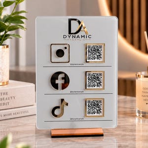 May include: A rectangular white acrylic sign with a gold base featuring the Dynamic Acrylic logo, social media icons for Instagram, Facebook, and TikTok, and three corresponding QR codes with the handle @dynamicacrylic printed below each icon.