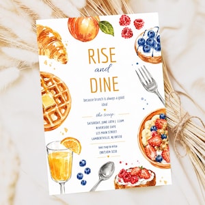 May include: A rectangular brunch invitation card featuring watercolour illustrations of a croissant, waffle, peach, berries, orange juice, and toast. The text reads: RISE and DINE, because brunch is always a good idea! the scoop: SATURDAY, JUNE 10TH | 11AM, RIVERSIDE CAFE, 123 MAIN STREET, LAMBERTVILLE, NJ 08530, text rsvp to erica (987) 654-3210.