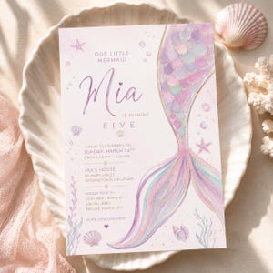 May include: A rectangular birthday invitation card featuring a watercolor mermaid tail in shades of purple, pink, and teal. The text reads: Our Little Mermaid Mia is turning five, join us to celebrate on Sunday, March 24th, from 1:00 PM to 4:00 PM.