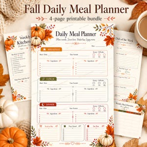 A flat lay displaying the four printable fall meal planner pages on a textured surface alongside pumpkins, a mug of tea, and autumn leaves.