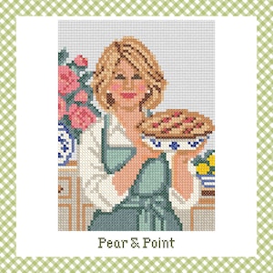 May include: A cross-stitch pattern featuring a person with blonde hair wearing a white shirt and a green apron, holding a pie in a blue and white patterned dish. To the left are pink flowers in a blue and white vase. The text Pear & Point is below.