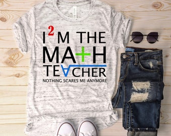 May include: A white t-shirt with a black and green graphic that says "I 2 M THE MA+H TE√CHER NOTHING SCARES ME ANYMORE".