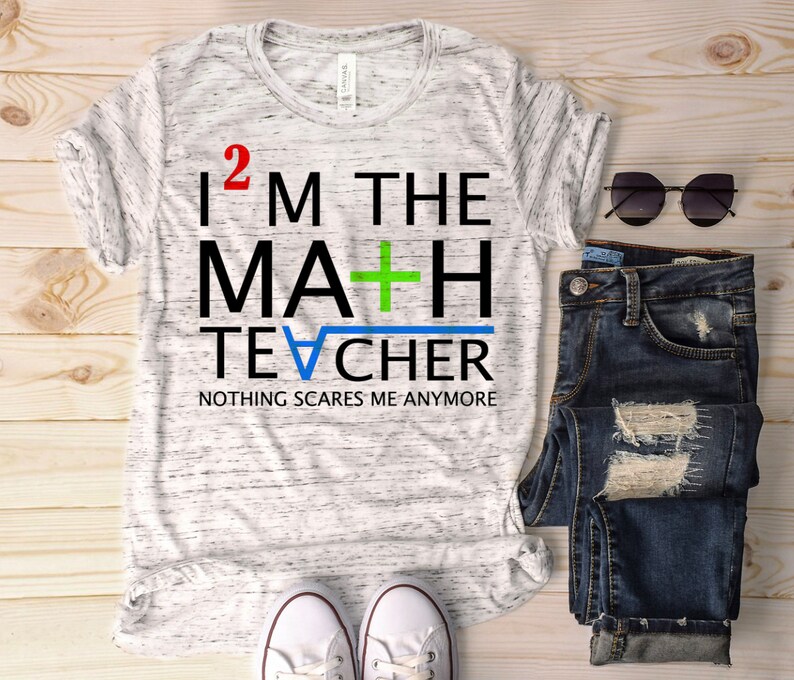 May include: A white t-shirt with a black and green graphic that says "I 2 M THE MA+H TE&radic;CHER NOTHING SCARES ME ANYMORE".
