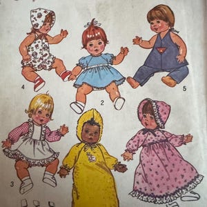 May include: Simplicity sewing pattern number 7208 for making doll clothes. The pattern includes six different outfits for a 13-14 inch doll. The outfits include a yellow sleeper, a pink dress, a blue dress, a white dress, a red and white jumpsuit, and a blue and white jumpsuit.