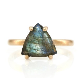 May include: A gold ring with a triangular iridescent labradorite gemstone.