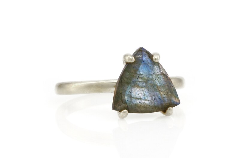 May include: A silver ring with a triangular iridescent labradorite gemstone.