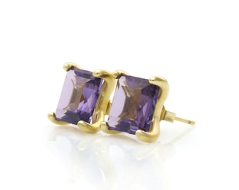 May include: A pair of gold earrings with square-shaped amethyst gemstones.