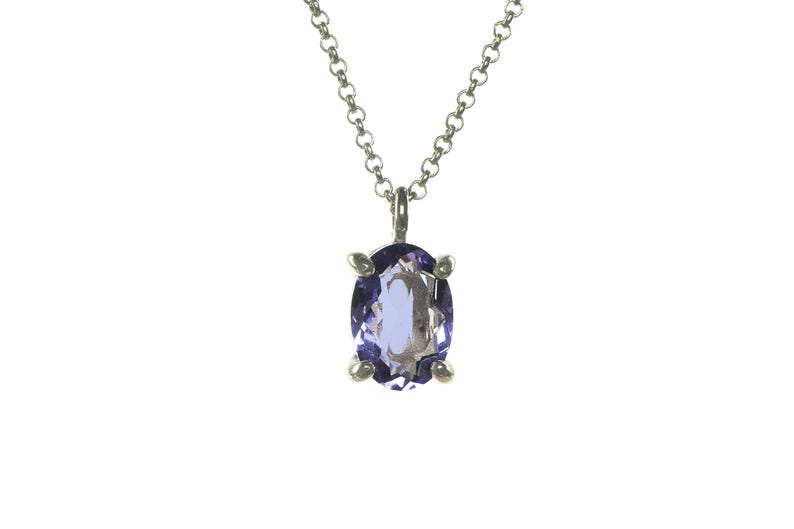 May include: A silver chain necklace with a purple oval gemstone pendant.