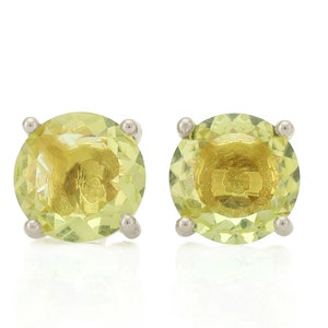 May include: A pair of silver stud earrings with round, light green gemstones.