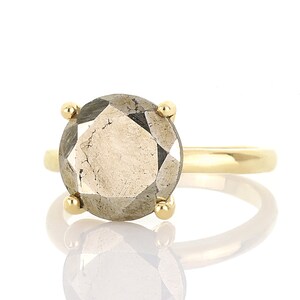 May include: A gold ring with a large, faceted, gray gemstone.