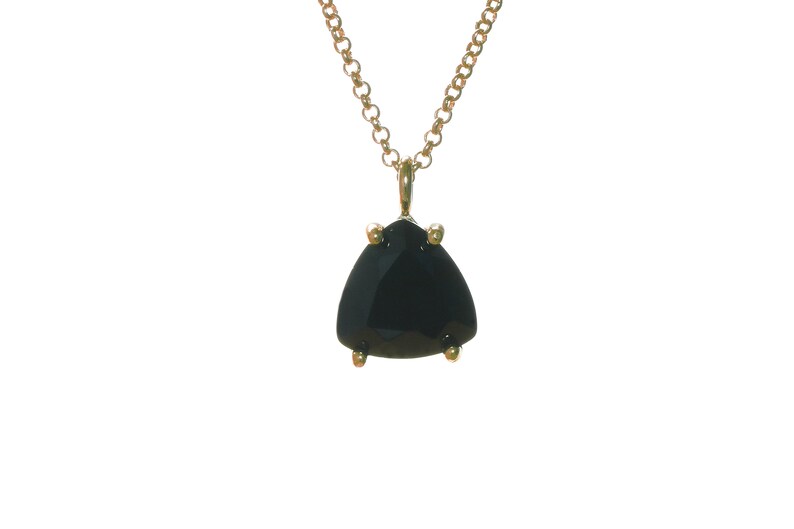 K&ouml;nnte beinhalten: Eine goldene Kettenkette mit einem schwarzen Edelstein-Anh&auml;nger. Der Anh&auml;nger hat eine dreieckige Form mit einem facettierten Schliff.